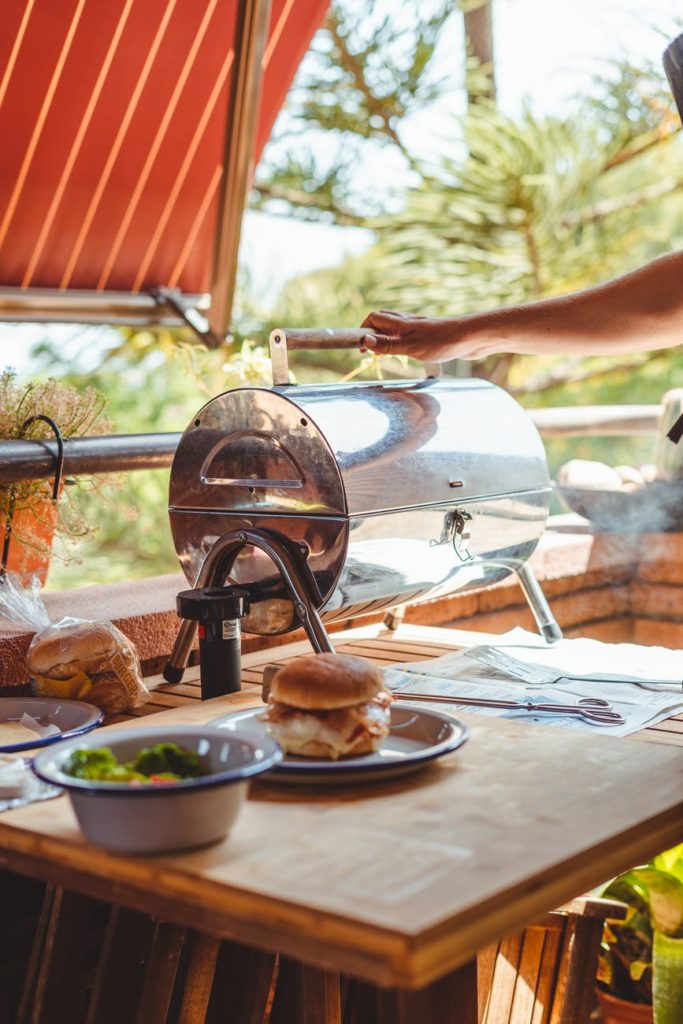 bbq tips crop person using grill while cooking